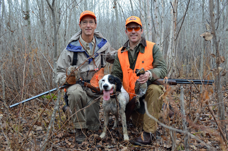 Hunters Dick Taylor, on left, and Henson Orser happily pose with their birds after a successful hunt behind Blue Shaquille. High stem density of the aspens combined with a rather open forest floor is a favorite habitat for ruffed grouse. 